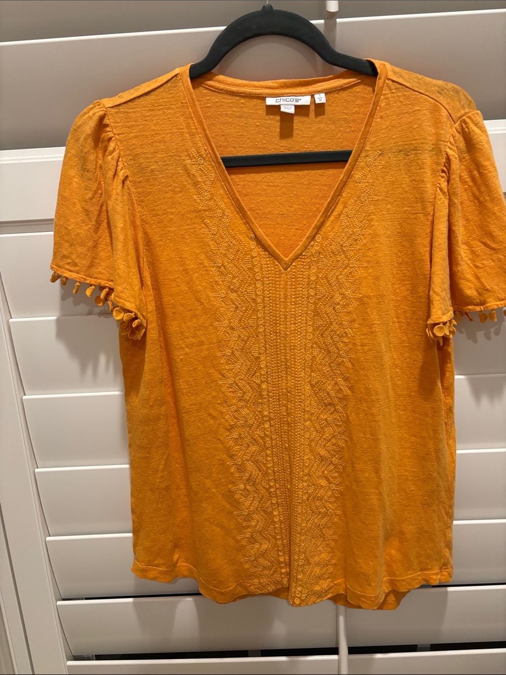 Chico's orange V-Neck Short Sleeve Top with Pom-Pom Trim
